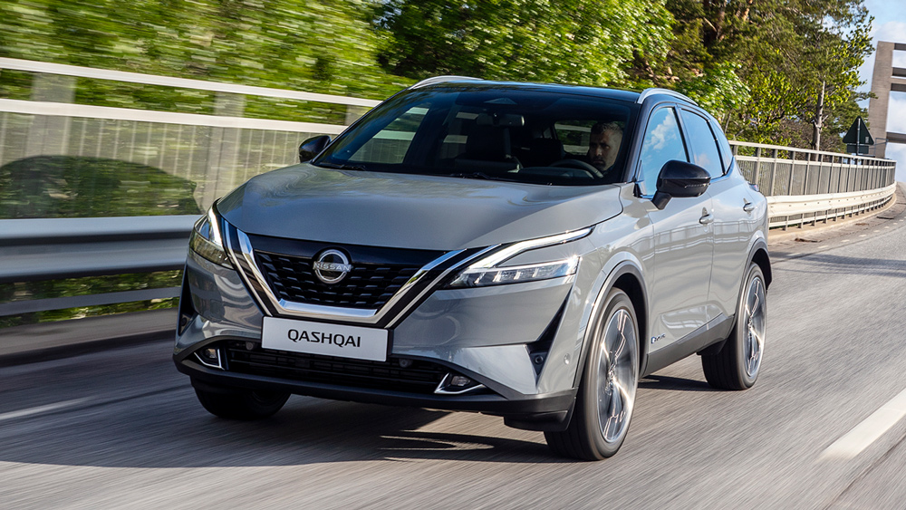 A grey Nissan Qashqai drives down the off ramp from a bridge